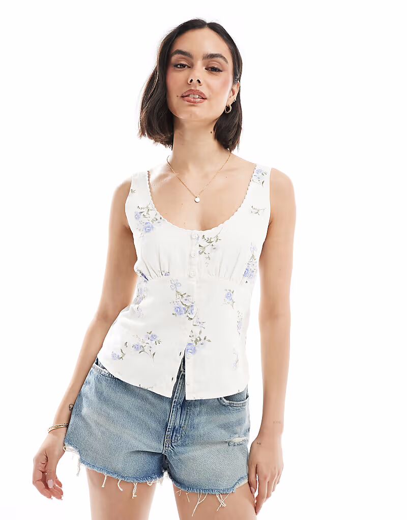 Топ Hollister из льна с глубоким вырезом на пуговицах в синем цветочном стиле
Топ Hollister из льна с глубоким вырезом на пуговицах в синем цветочном стиле