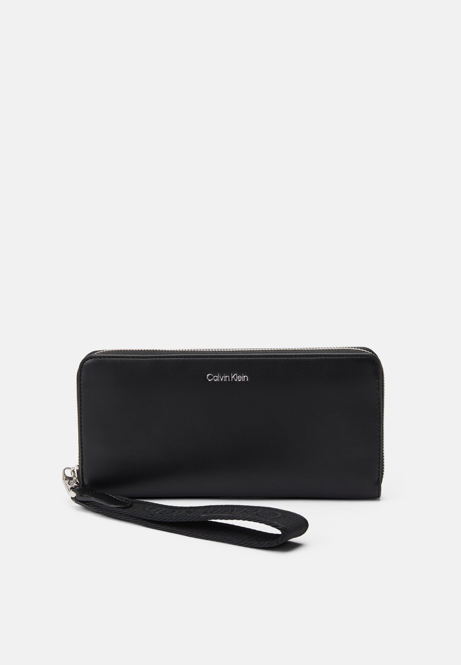 Кошелек Calvin Klein STRAP LONG ZIP AROUND, Black
Кошелек Calvin Klein STRAP LONG ZIP AROUND, Black