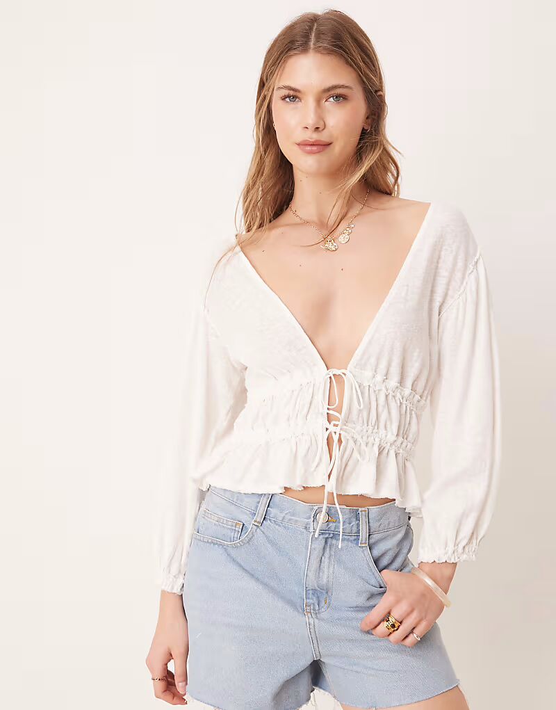 Блузка Free People из джерси с завязками спереди цвета слоновой кости
Блузка Free People из джерси с завязками спереди цвета слоновой кости