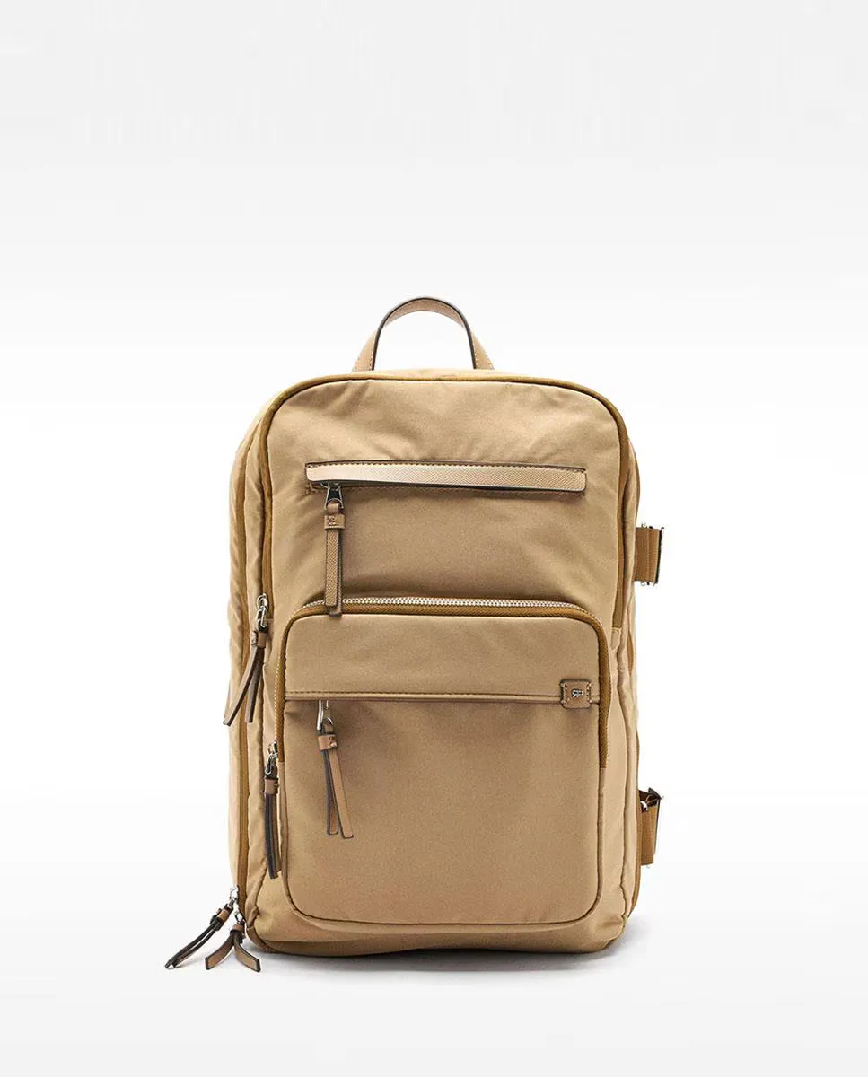 Женский рюкзак для путешествий с ручной кладью, который можно приспособить к чемодану на колесиках, с застежкой-молнией и несколькими карманами в однотонном исполнении Parfois, светло-коричневый 
Женский рюкзак для путешествий с ручной кладью, который можно приспособить к чемодану на колесиках, с застежкой-молнией и несколькими карманами в однотонном исполнении Parfois, светло-коричневый