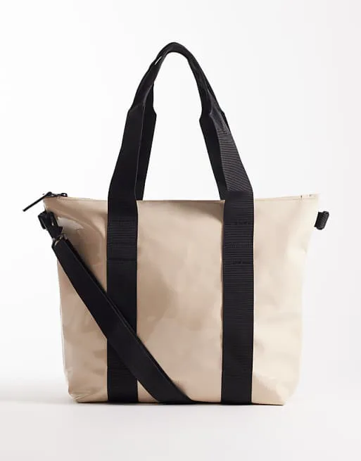 Водонепроницаемая мини-сумка Rains 14160 с кремовым блеском
Водонепроницаемая мини-сумка Rains 14160 с кремовым блеском