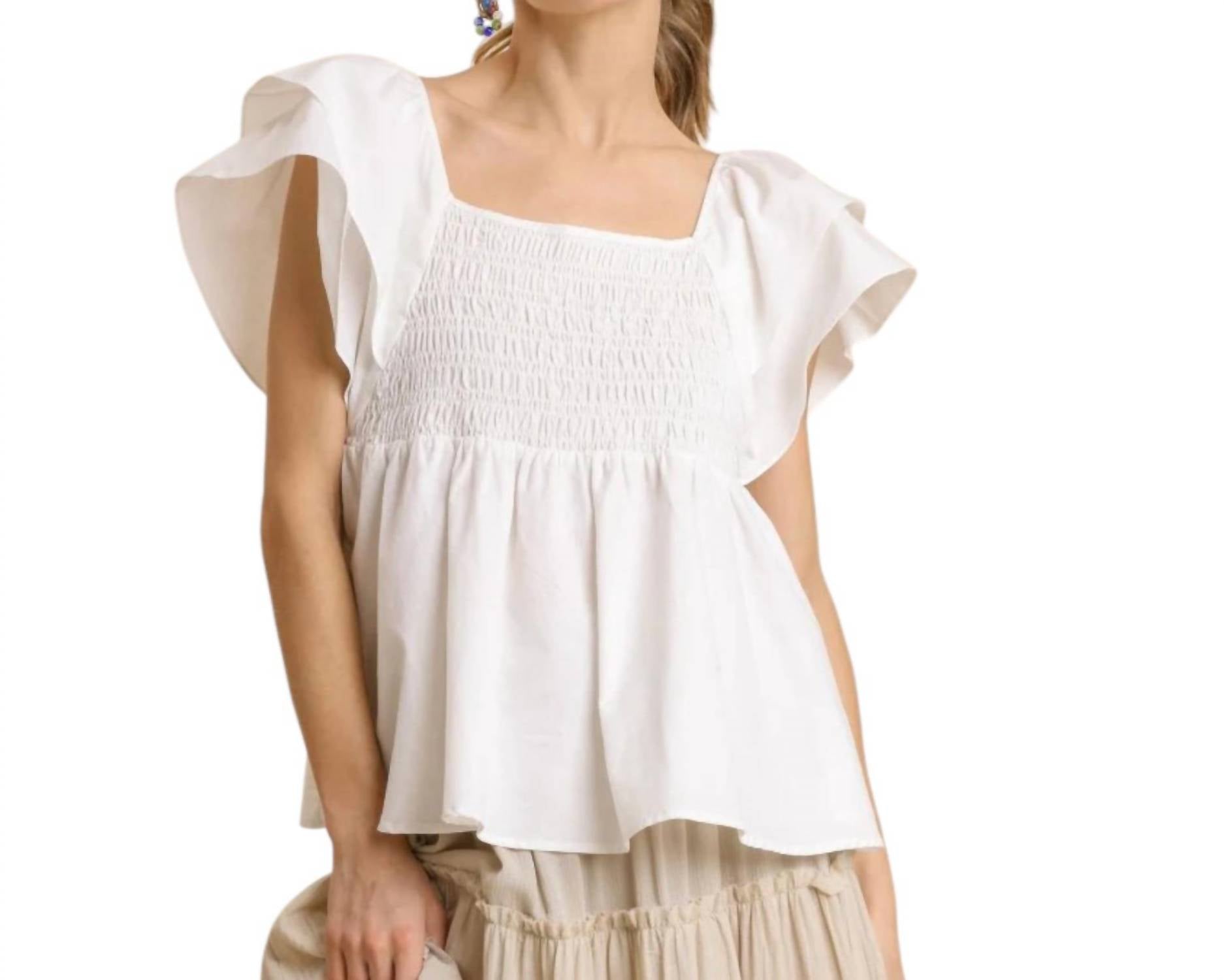 Белая блузка с рюшами и сборками из поплина Umgee
Белая блузка с рюшами и сборками из поплина Umgee