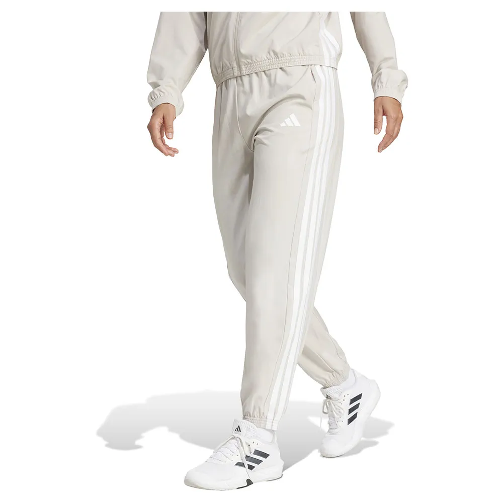 Джоггеры adidas Train Essentials 3 Stripes Woven, бежевый 
Джоггеры adidas Train Essentials 3 Stripes Woven, бежевый