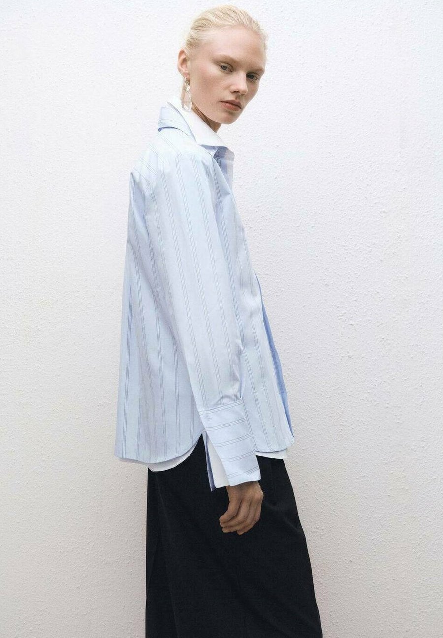 Блуза Mango Button-down blouse, Light Blue
Блуза Mango Button-down blouse, Light Blue