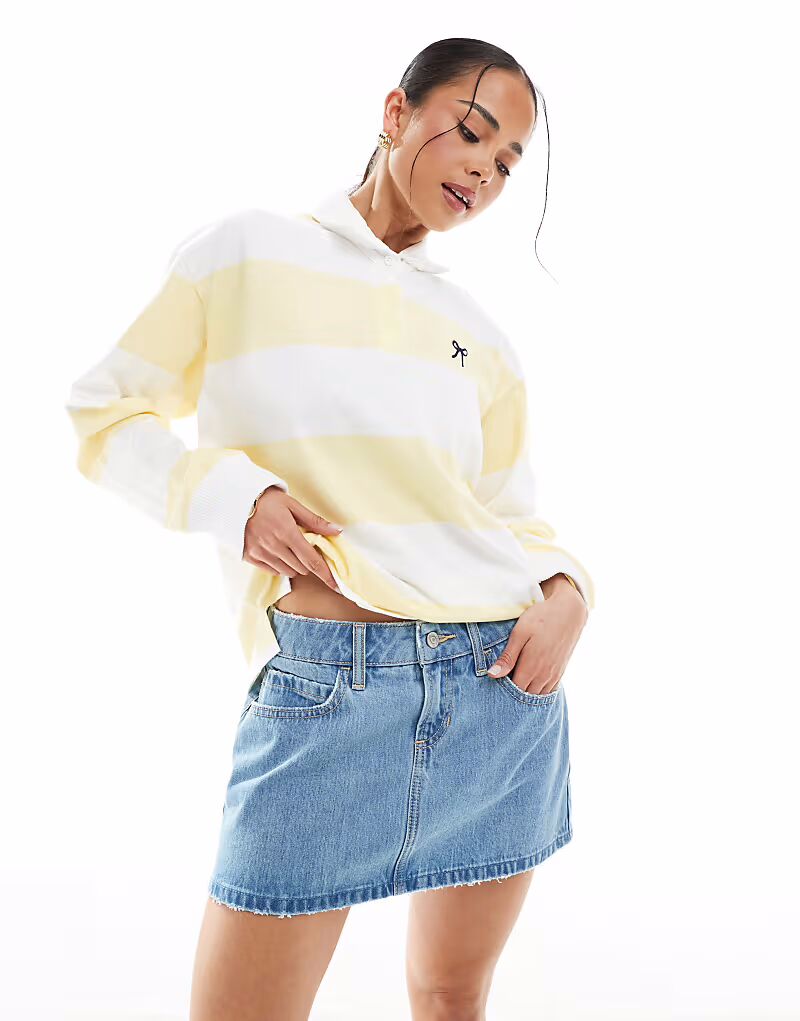 Мини-юбка Hollister из денима с низкой посадкой и потертостями в средне-синем цвете
Мини-юбка Hollister из денима с низкой посадкой и потертостями в средне-синем цвете