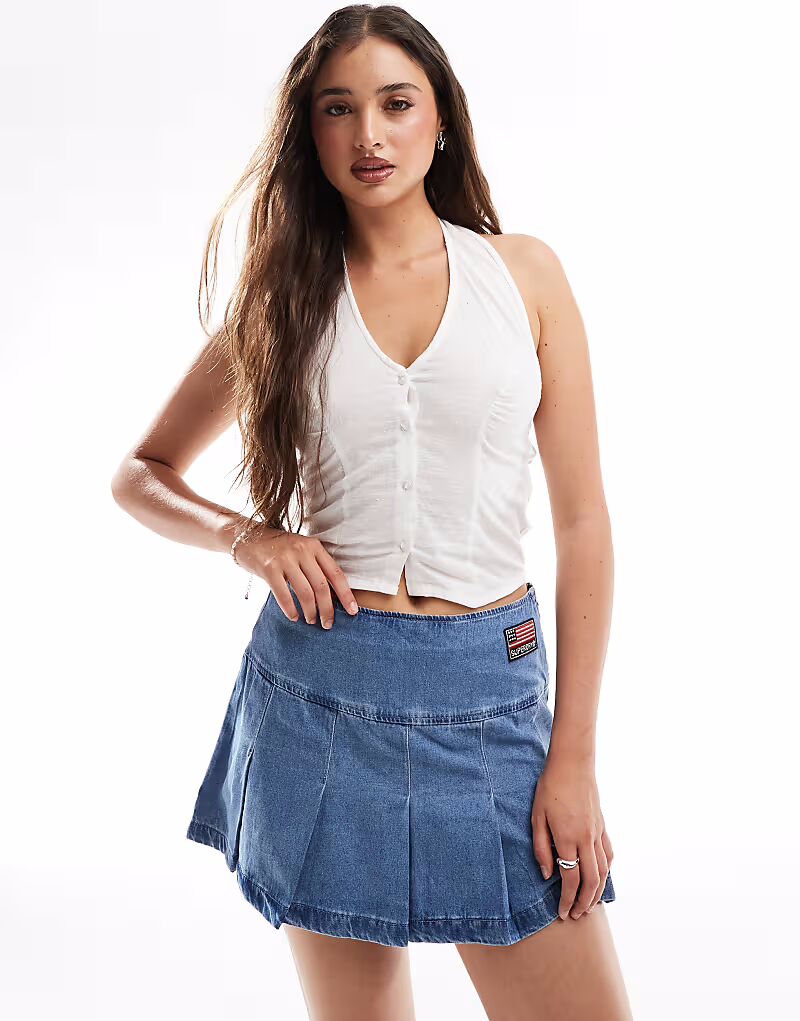 Мини-юбка Superdry с плиссировкой и заплатками в винтажном стиле
Мини-юбка Superdry с плиссировкой и заплатками в винтажном стиле