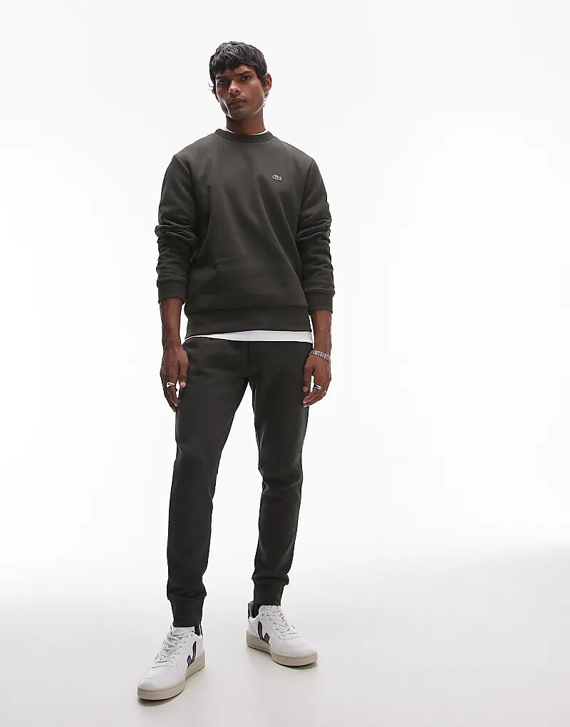 Узкие спортивные штаны с логотипом цвета кахки Lacoste
Узкие спортивные штаны с логотипом цвета кахки Lacoste