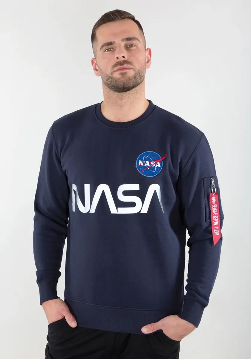 Свитер Alpha Industries " Alpha Industries Мужчины - Толстовки Светоотражающий свитер NASA", синий 
Свитер Alpha Industries " Alpha Industries Мужчины - Толстовки Светоотражающий свитер NASA", синий