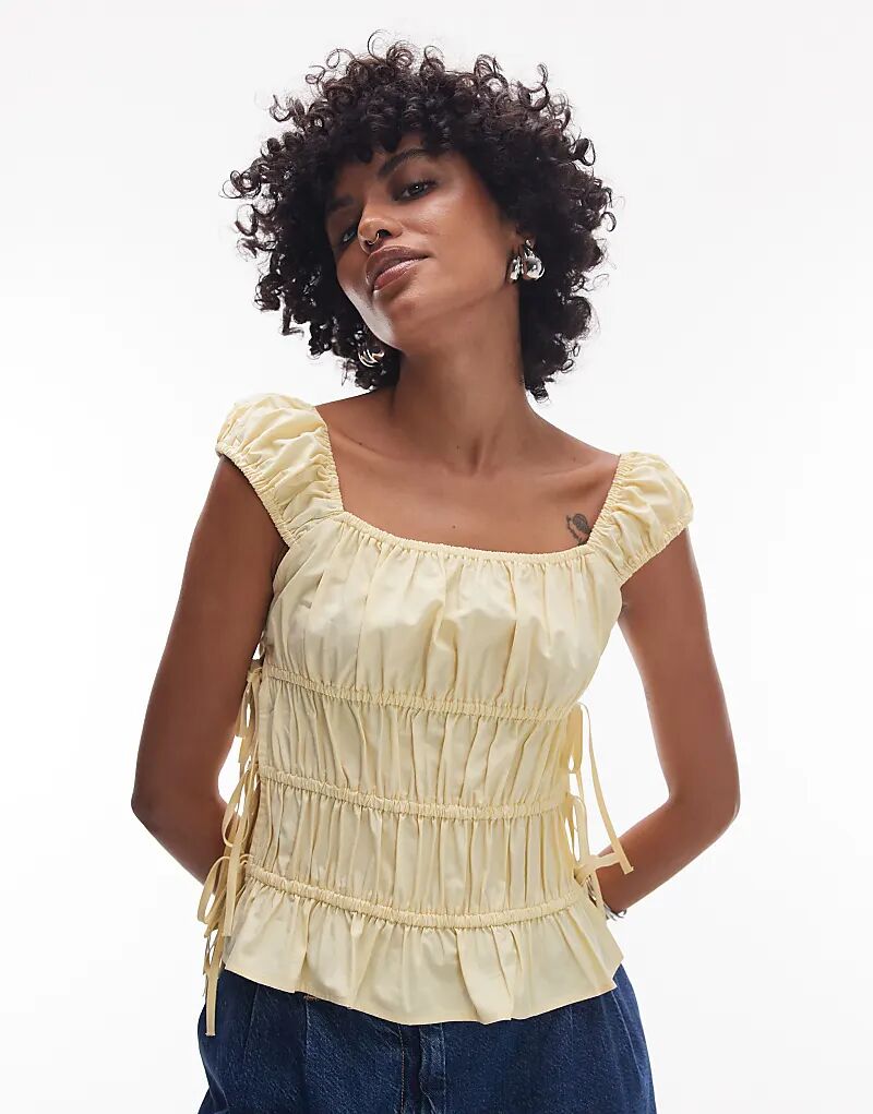 Топ Topshop с завязками по бокам, собранный в рюши, цвета пахты
Топ Topshop с завязками по бокам, собранный в рюши, цвета пахты