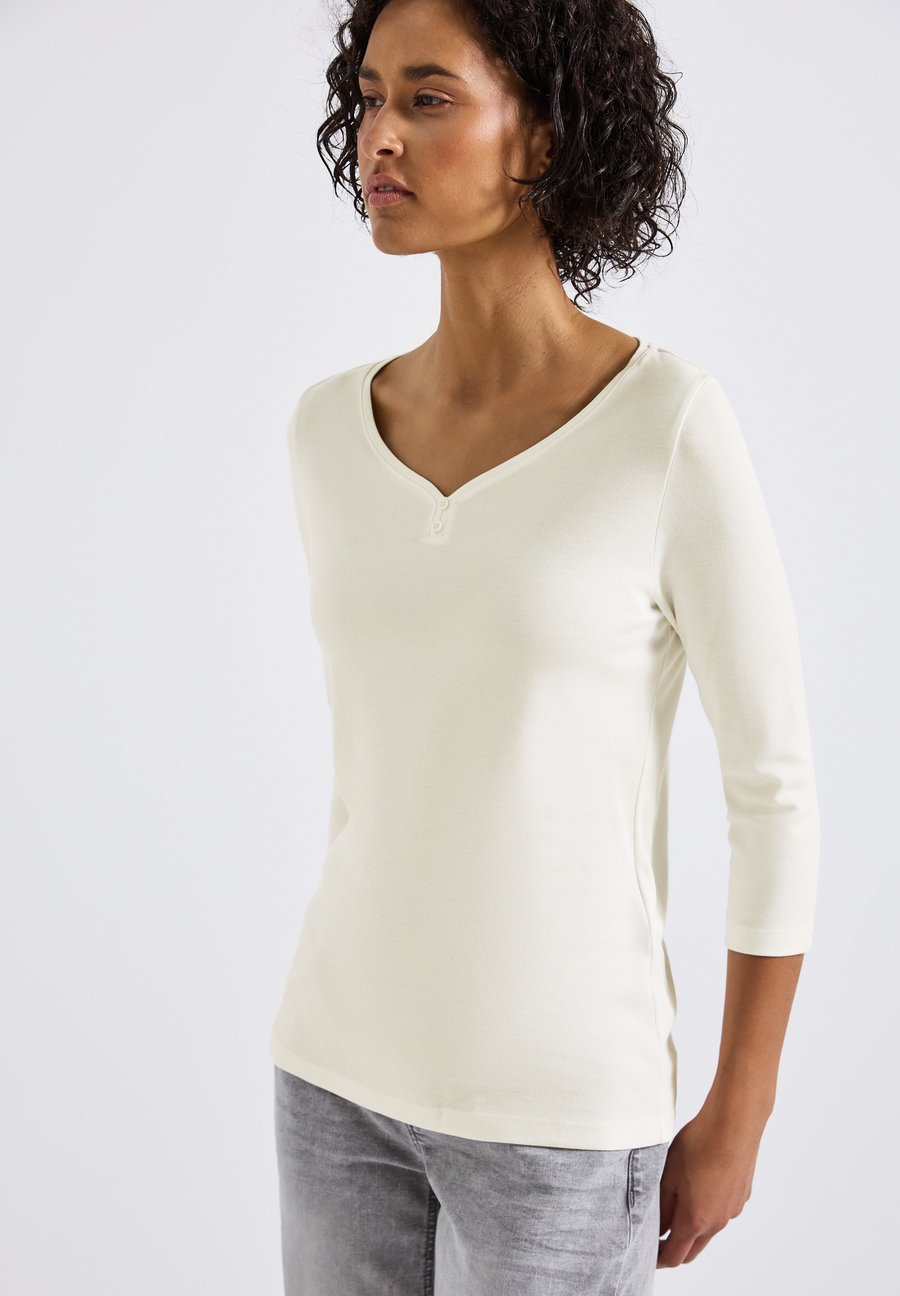 Топ Street One BASIC MIT KNOPFDETAIL, Weiß/Off-White
Топ Street One BASIC MIT KNOPFDETAIL, Weiß/Off-White