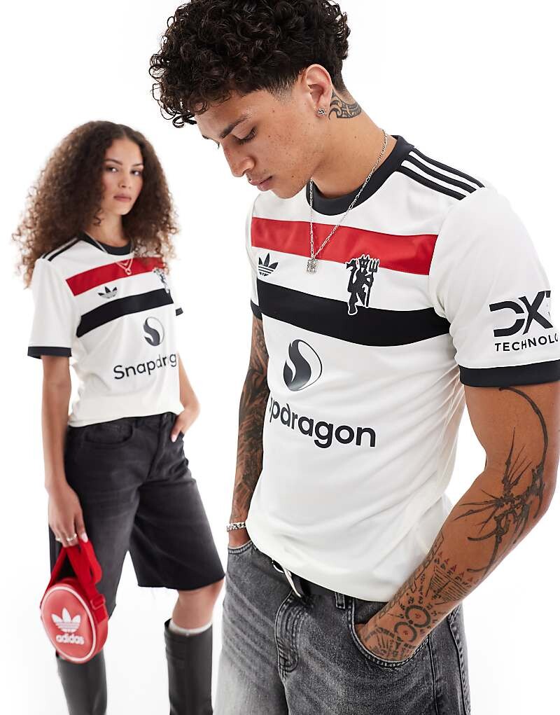 Бело-красная и синяя третья рубашка унисекс adidas Football Manchester United 24/25
Бело-красная и синяя третья рубашка унисекс adidas Football Manchester United 24/25