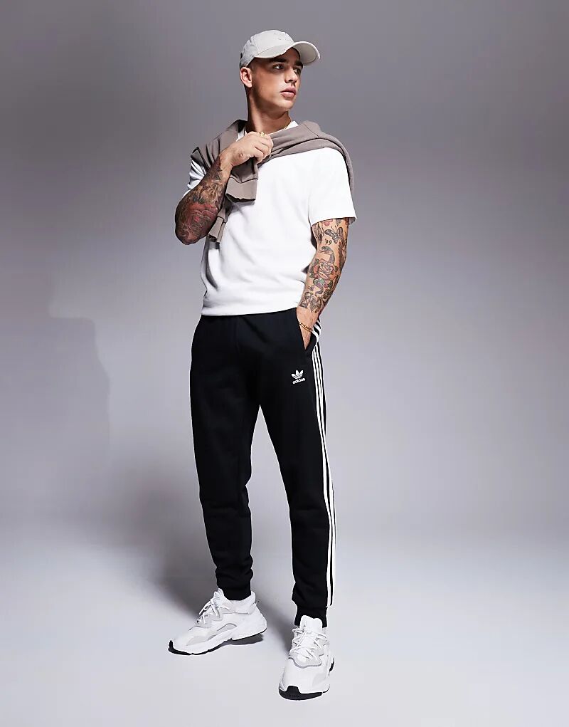 Джоггеры с тремя полосками черного цвета adidas Originals
Джоггеры с тремя полосками черного цвета adidas Originals