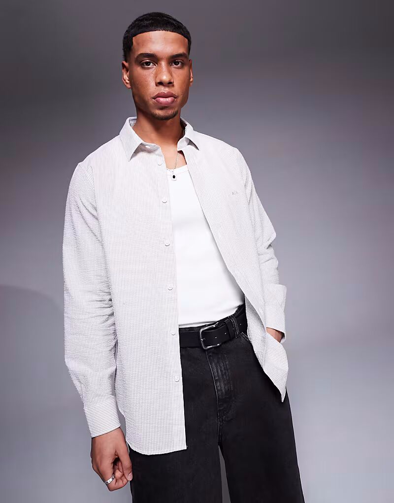 Рубашка с полосатым логотипом Armani Exchange белого и бежевого цветов
Рубашка с полосатым логотипом Armani Exchange белого и бежевого цветов