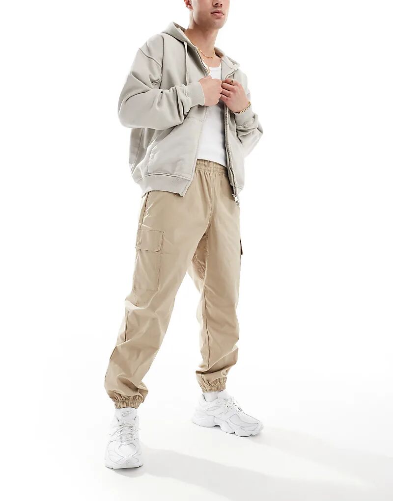 Спортивные брюки-карго Vip из твила - бежевого цвета New Balance
Спортивные брюки-карго Vip из твила - бежевого цвета New Balance