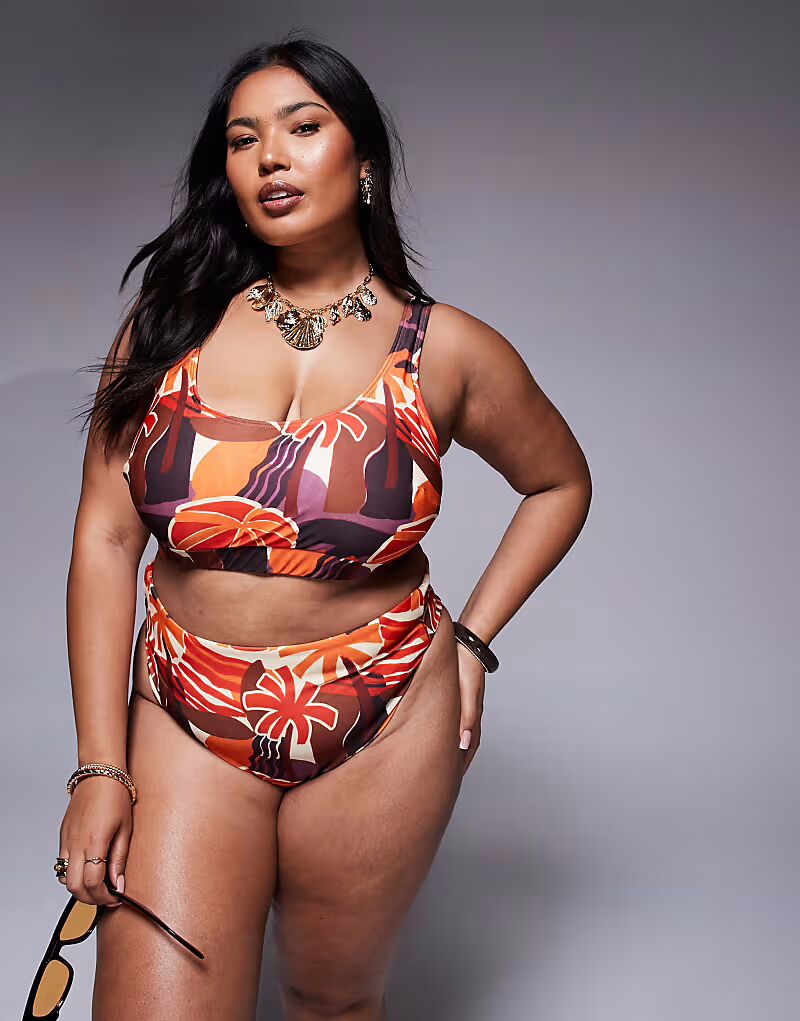 Плавки-бикини Curve Ava с высокой талией и высоким вырезом на бедрах с тропическим принтом Asos Curve
Плавки-бикини Curve Ava с высокой талией и высоким вырезом на бедрах с тропическим принтом Asos Curve