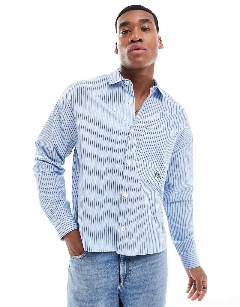 ASOS DESIGN – синяя рубашка свободного кроя в тонкую полоску с вышитыми надписями
ASOS DESIGN – синяя рубашка свободного кроя в тонкую полоску с вышитыми надписями