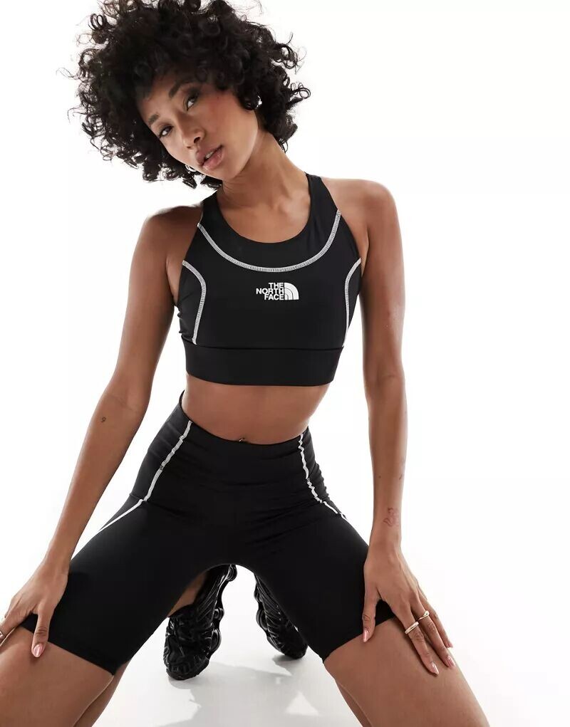 Черный спортивный бюстгальтер средней поддержки с контурным швом The North Face Training Hakuun
Черный спортивный бюстгальтер средней поддержки с контурным швом The North Face Training Hakuun
