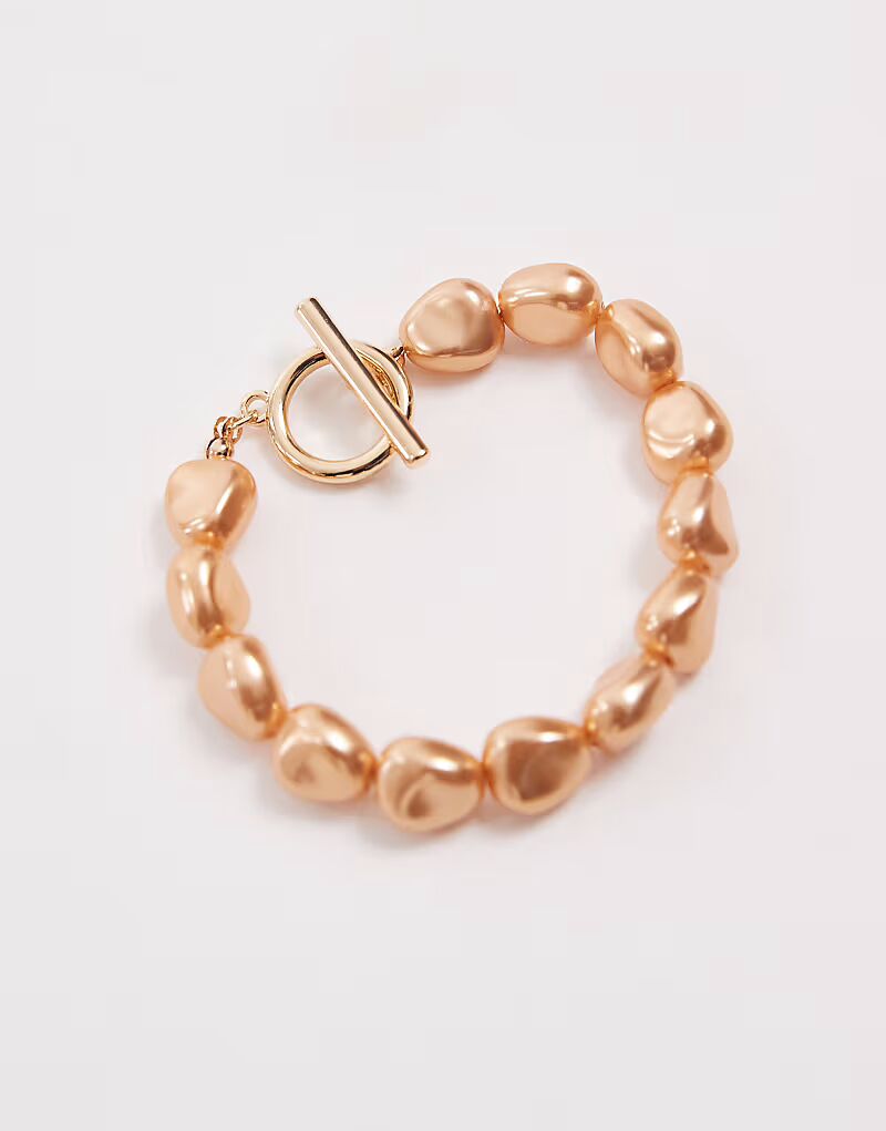 Браслет с Т-образной застежкой и отделкой из искусственного жемчуга золотистого оттенка Asos Design
Браслет с Т-образной застежкой и отделкой из искусственного жемчуга золотистого оттенка Asos Design