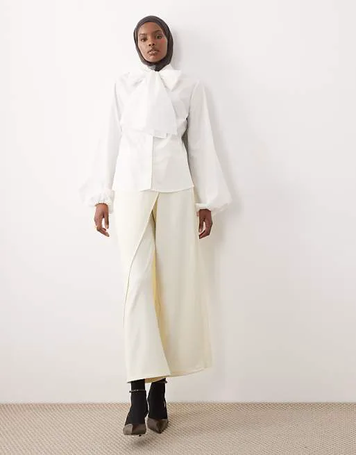 Кремовые брюки с юбкой с запахом IAAL
Кремовые брюки с юбкой с запахом IAAL