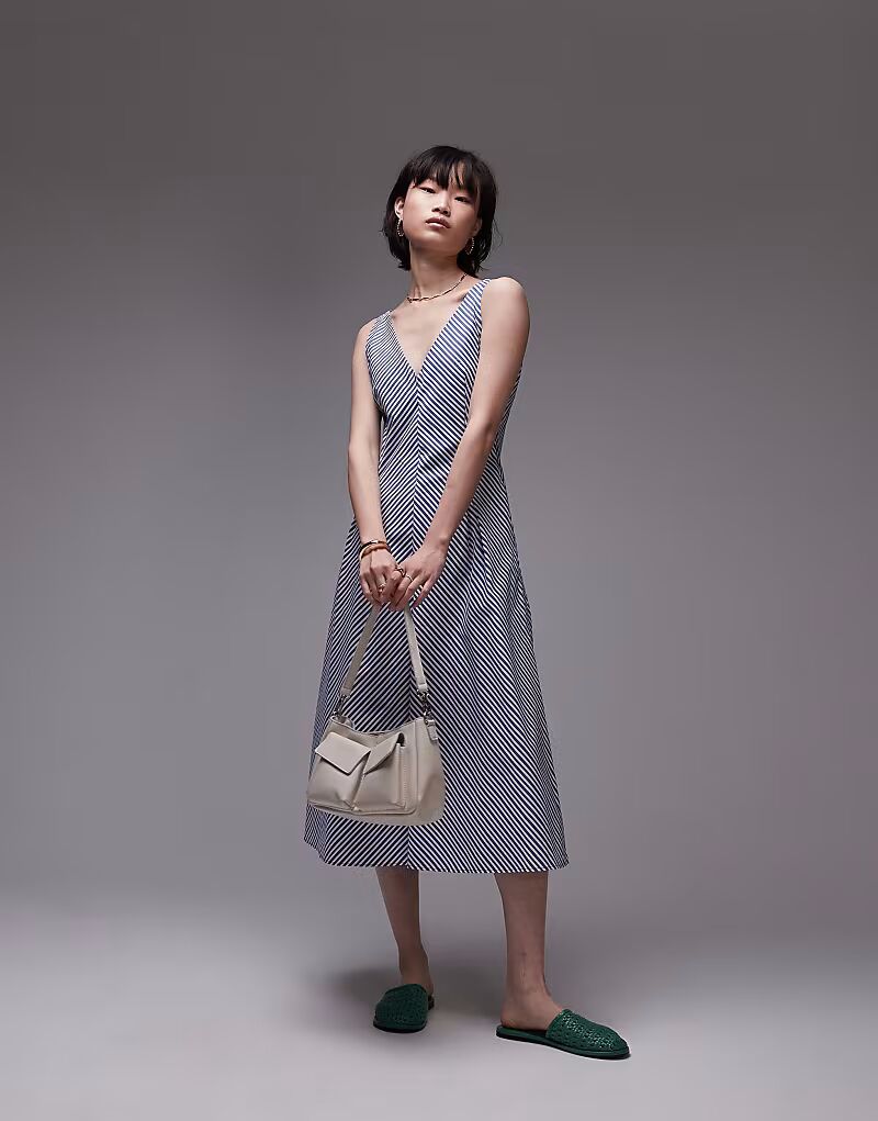 Платье-миди из хлопка Mango с v-образным вырезом в синюю полоску
Платье-миди из хлопка Mango с v-образным вырезом в синюю полоску