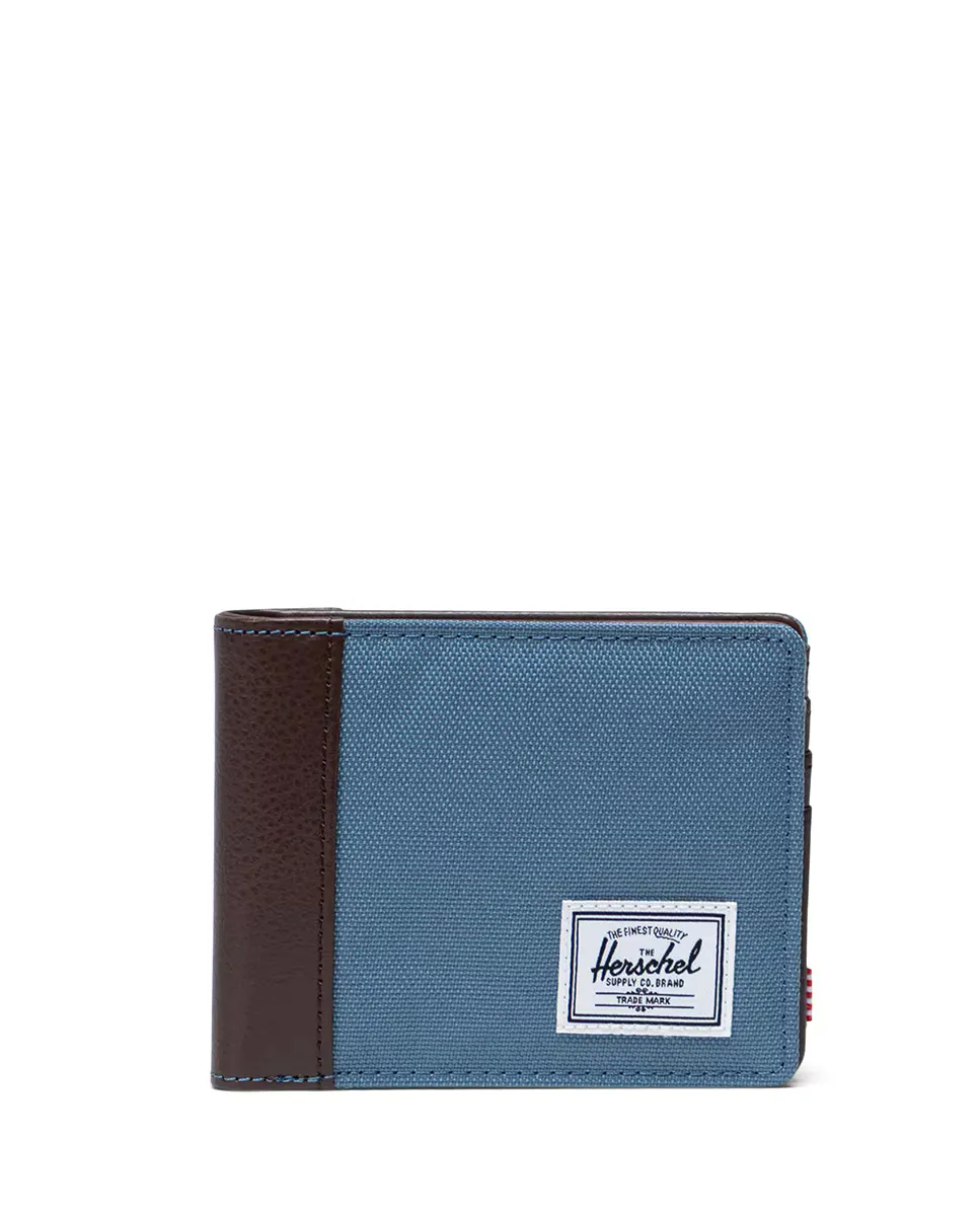 Мужской экологичный синий складной кошелек с коричневой веганской кожей сбоку Herschel
Мужской экологичный синий складной кошелек с коричневой веганской кожей сбоку Herschel