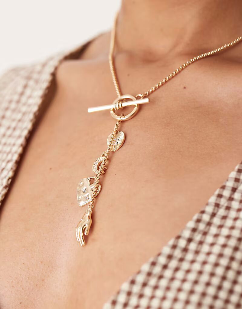 Длинное ожерелье с подвесками в виде Т-образной планки золотистого оттенка Asos Design
Длинное ожерелье с подвесками в виде Т-образной планки золотистого оттенка Asos Design