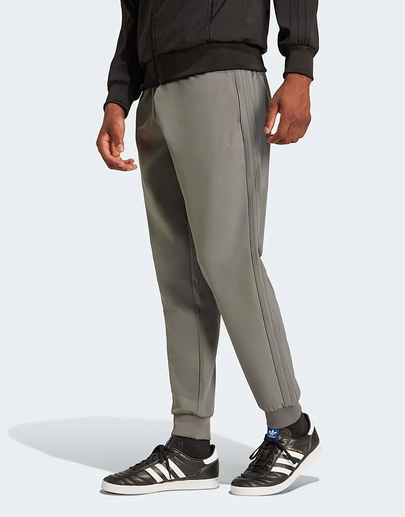 Спортивные брюки из SSt с клееным покрытием серого цвета adidas Originals
Спортивные брюки из SSt с клееным покрытием серого цвета adidas Originals