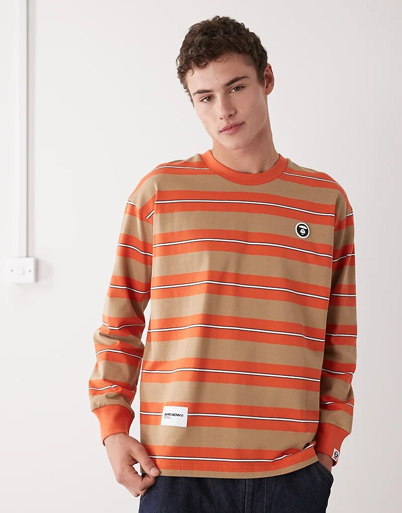 Футболка свободного кроя с длинными рукавами Aape by A Bathing Ape в полоску коричневого и оранжевого цветов
Футболка свободного кроя с длинными рукавами Aape by A Bathing Ape в полоску коричневого и оранжевого цветов