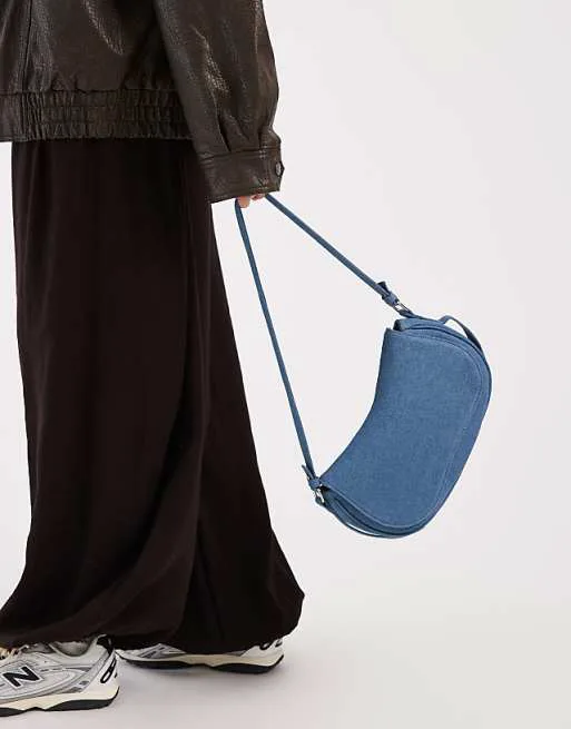 Гламурная мини-сумка-седло из синего денима
Гламурная мини-сумка-седло из синего денима