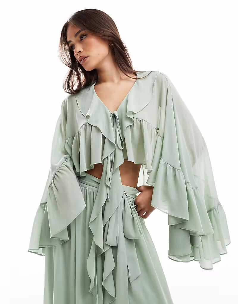 Топ TFNC tie front cape top with ruffle detail in sage green co-ord
Топ TFNC tie front cape top with ruffle detail in sage green co-ord