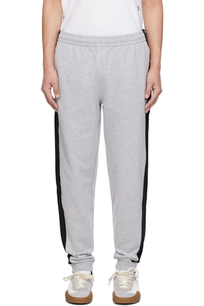 Серо-черные зауженные спортивные штаны с цветными блоками Lacoste
Серо-черные зауженные спортивные штаны с цветными блоками Lacoste