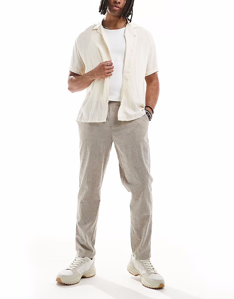 Узкие зауженные льняные брюки на шнурке от Jack & Jones бежевого цвета
Узкие зауженные льняные брюки на шнурке от Jack & Jones бежевого цвета