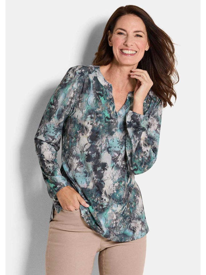 Блузка из джерси. Элегантная блузка-рубашка с V-образным вырезом в сине-зеленого цвета с узором. GOLDNER
Блузка из джерси. Элегантная блузка-рубашка с V-образным вырезом в сине-зеленого цвета с узором. GOLDNER