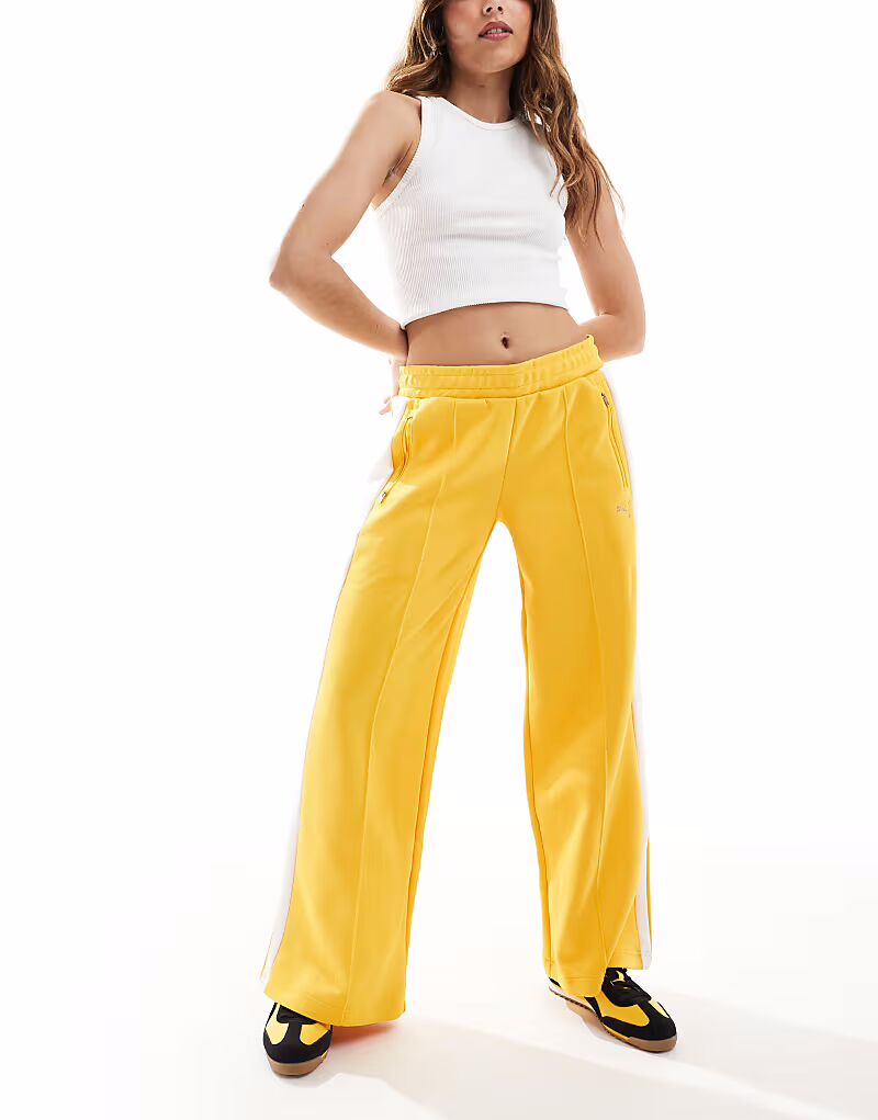 Спортивные брюки Puma T7 с низкой посадкой желтого цвета
Спортивные брюки Puma T7 с низкой посадкой желтого цвета