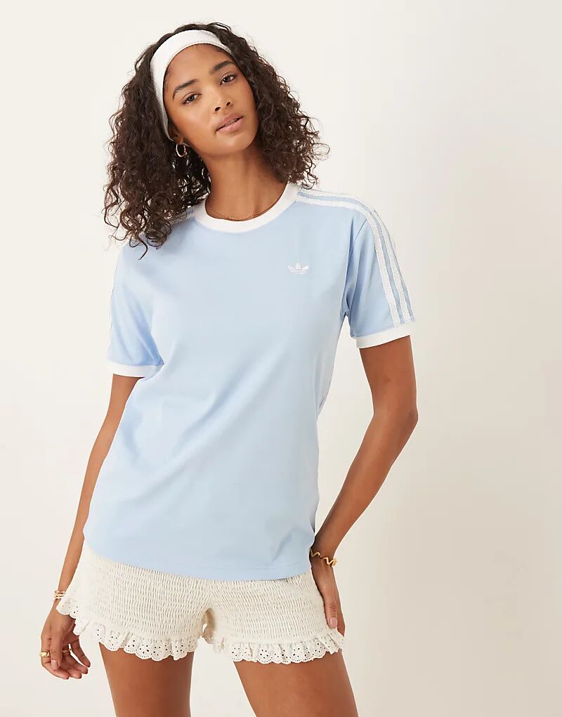 Футболка adidas Originals Ringer синего цвета с рюшами и тремя полосками
Футболка adidas Originals Ringer синего цвета с рюшами и тремя полосками