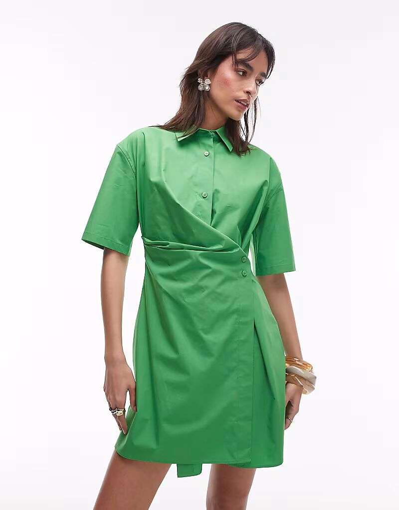 Платье-рубашка мини ARKET из хлопка с запахом на пуговицах спереди зеленого цвета
Платье-рубашка мини ARKET из хлопка с запахом на пуговицах спереди зеленого цвета