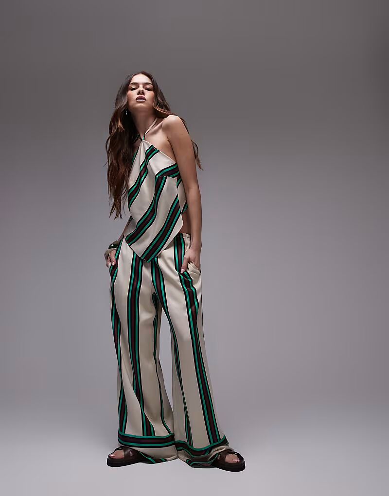 Атласные брюки Topshop co-ord средней посадки с глубокими манжетами бежевого цвета с полосками бордового и бирюзового цвета 
Атласные брюки Topshop co-ord средней посадки с глубокими манжетами бежевого цвета с полосками бордового и бирюзового цвета