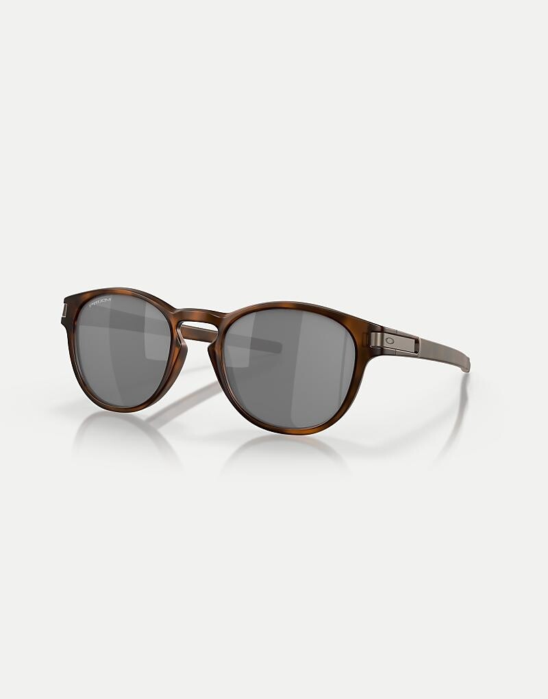 Круглые солнцезащитные очки Oakley Latch™ в матово-коричневой черепаховой расцветке с серыми зеркальными линзами
Круглые солнцезащитные очки Oakley Latch™ в матово-коричневой черепаховой расцветке с серыми зеркальными линзами