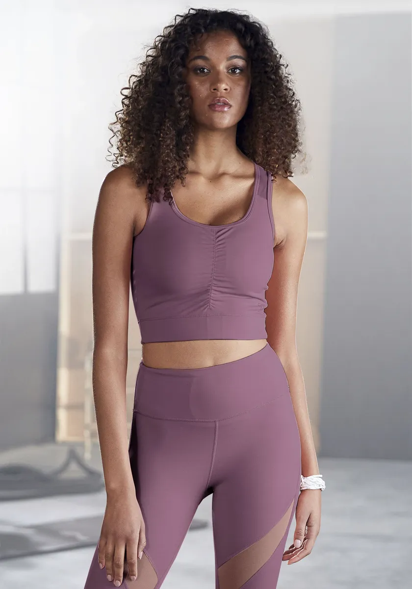 Укороченный топ LASCANA ACTIVE "Sport Top" с рюшами и сетчатыми вставками, фиолетовый
Укороченный топ LASCANA ACTIVE "Sport Top" с рюшами и сетчатыми вставками, фиолетовый