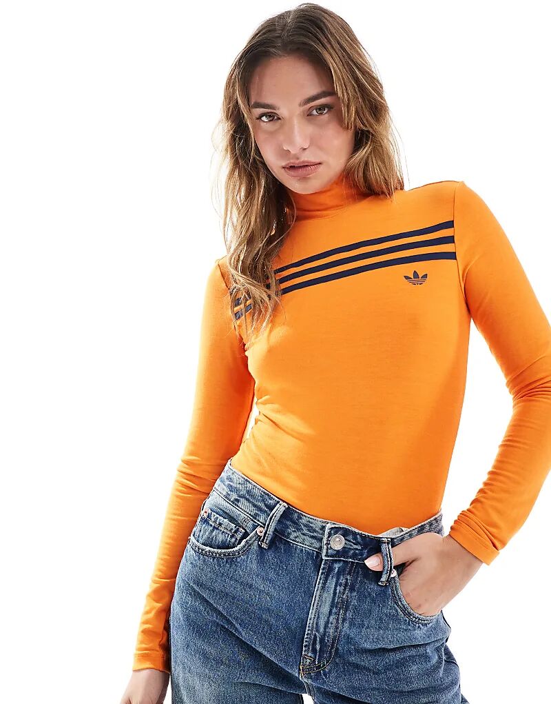Топ с тремя полосками и длинными рукавами в стиле 70-х оранжевого цвета adidas Originals
Топ с тремя полосками и длинными рукавами в стиле 70-х оранжевого цвета adidas Originals