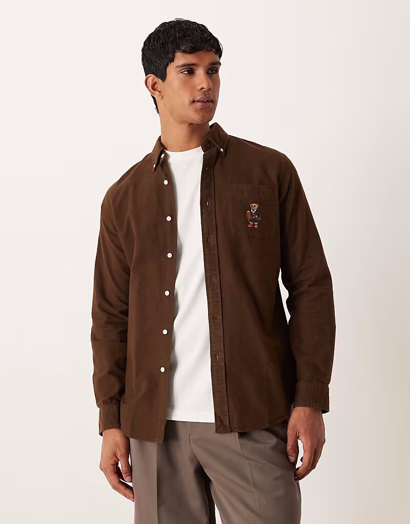 Рубашка оксфорд с логотипом медведя, коричневого цвета, с начесом, индивидуальная посадка Polo Ralph Lauren
Рубашка оксфорд с логотипом медведя, коричневого цвета, с начесом, индивидуальная посадка Polo Ralph Lauren