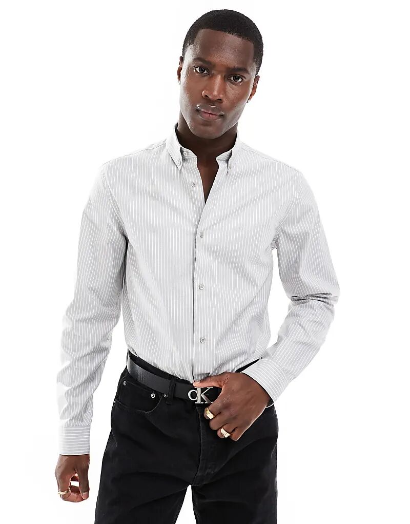 Полосатая рубашка оксфорд светло-серого цвета Calvin Klein
Полосатая рубашка оксфорд светло-серого цвета Calvin Klein