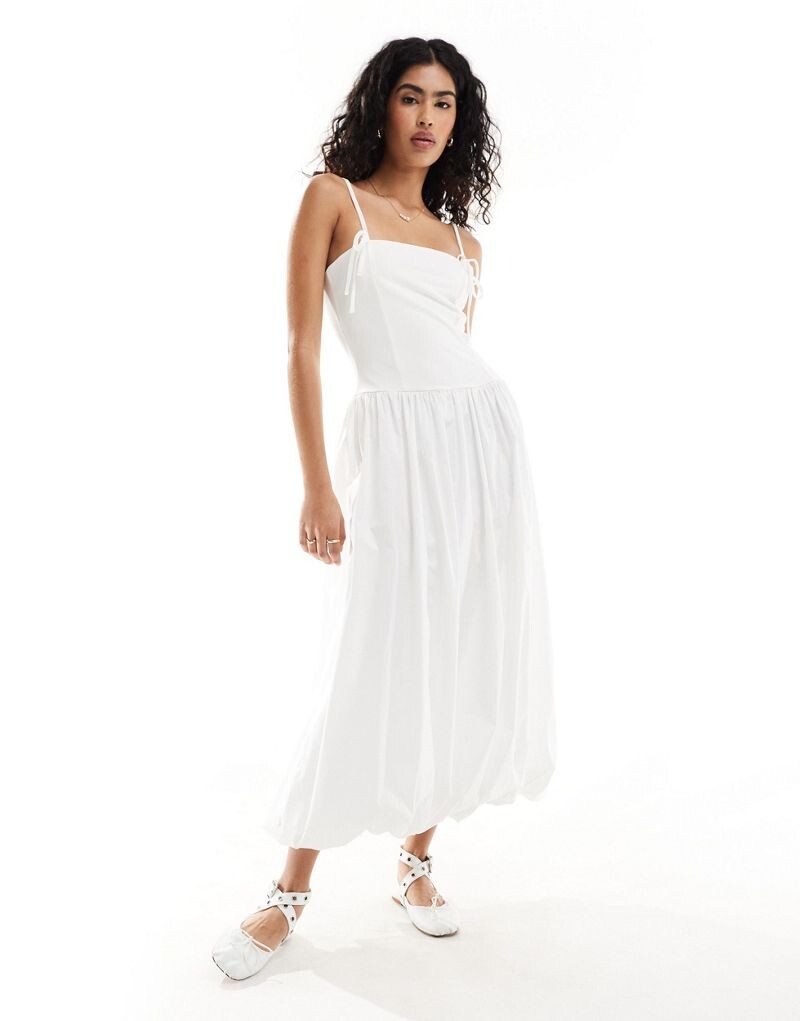 Однотонное платье с заниженной талией на тонких бретелях ASOS DESIGN, поплиновой юбкой длиной до икры и объемным подолом
Однотонное платье с заниженной талией на тонких бретелях ASOS DESIGN, поплиновой юбкой длиной до икры и объемным подолом