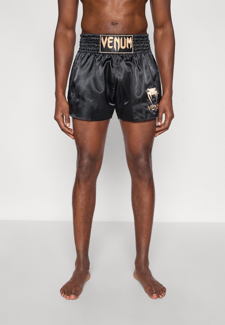 Спортивные шорты Venum CLASSIC MUAY THAI SHORT UNISEX, Black/Gold-Coloured/Black
Спортивные шорты Venum CLASSIC MUAY THAI SHORT UNISEX, Black/Gold-Coloured/Black