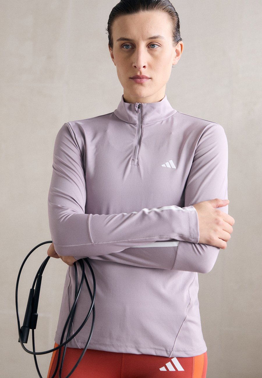 Топ Adidas Performance 1/4 ZIP, Preloved Fig/White/Lilac
Топ Adidas Performance 1/4 ZIP, Preloved Fig/White/Lilac
