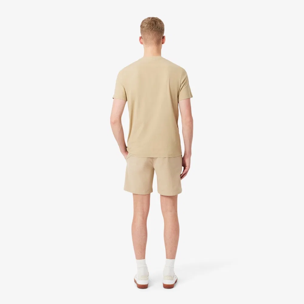 Мужские эластичные шорты-бермуды из полиэстера бежевые от Lacoste — фото 3