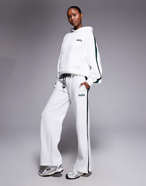 

Бело-темно-зеленые джоггеры широкого кроя с полосками по бокам Kaiia