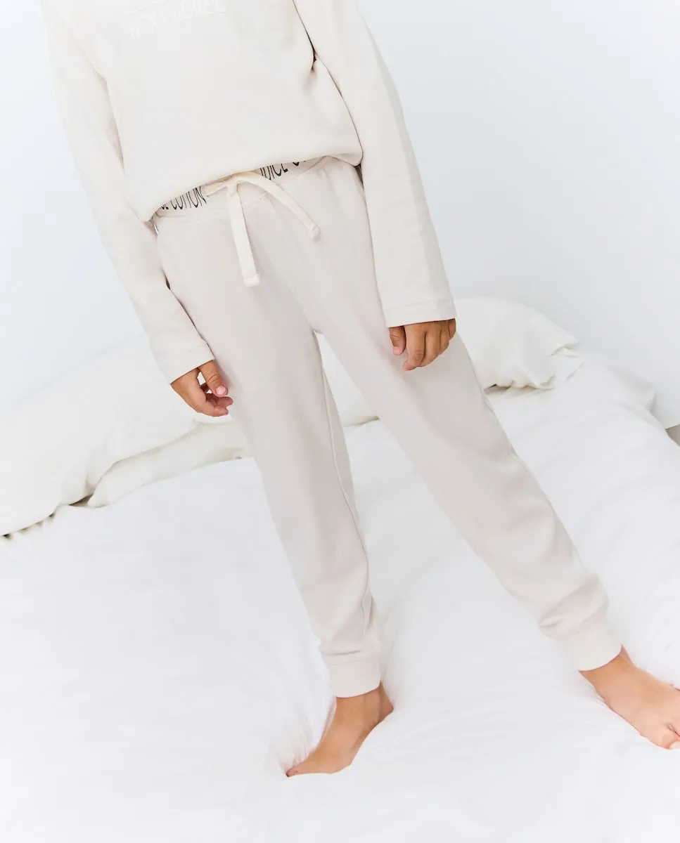 

Детские длинные брюки из однотонного трикотажа Cotton Juice, бежевый