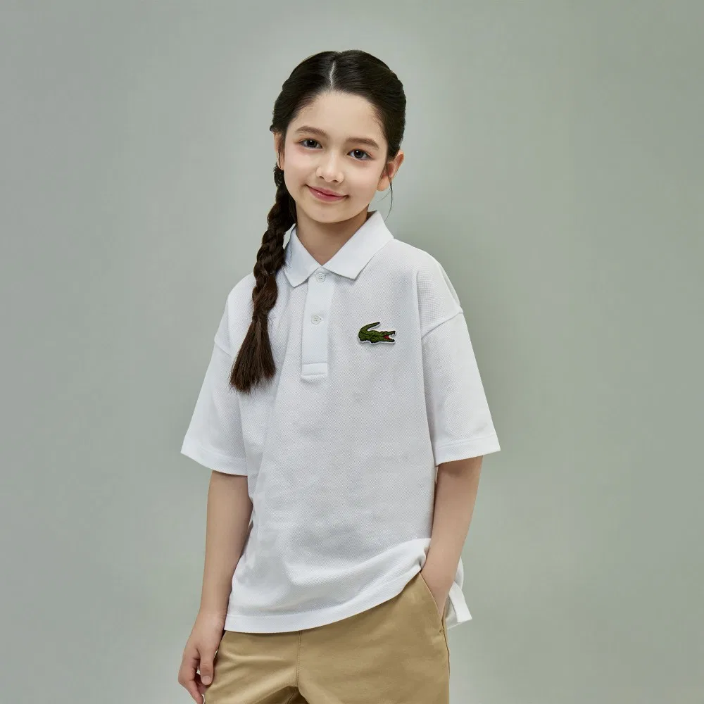 Детская рубашка-поло свободного кроя с коротким рукавом белого цвета от Lacoste