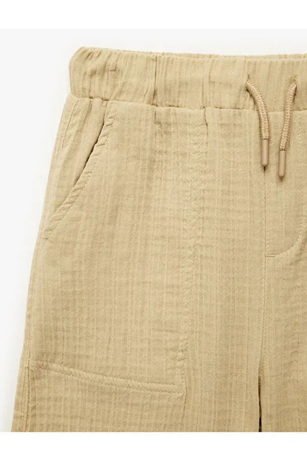 Детские шорты для мальчиков хлопковые Relaxed fit muslin shorts with pockets Koton, Beige — фото 4